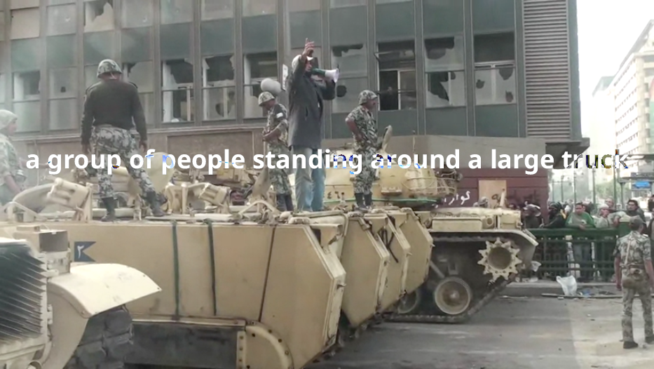 A group of people standing around a large truck